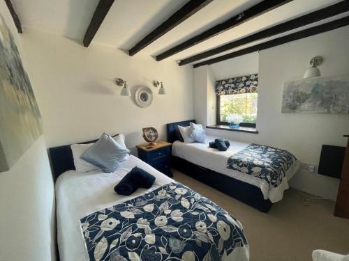 a bedroom with two beds and a window at 4 Bed in Bodmin oc-90215 in Bodmin