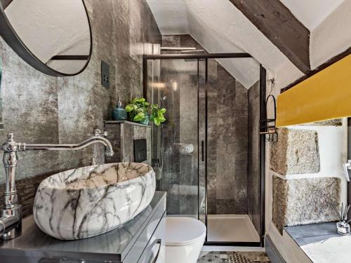 a bathroom with a marble sink and a shower at 3 Bed in Bodmin oc-90217 in Bodmin