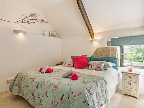 a bedroom with two beds with red pillows at 3 Bed in Bodmin oc-90217 in Bodmin