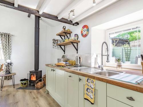 a kitchen with a sink and a stove at 1 Bed in Bodmin oc-88165 in Bodmin