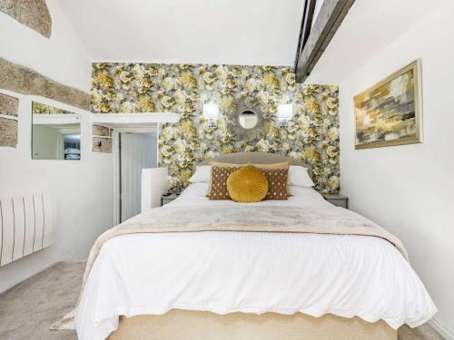 a bedroom with a white bed with a yellow pillow at 1 Bed in Bodmin oc-88165 in Bodmin