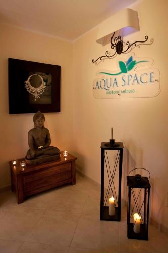 a meditation room with a statue on a table and lights at Mira Spiaggia in San Vito lo Capo