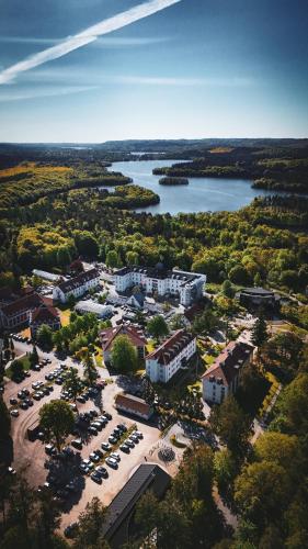an aerial view of a resort with a parking lot at Vejlsøhus Hotel and Conference Center in Silkeborg