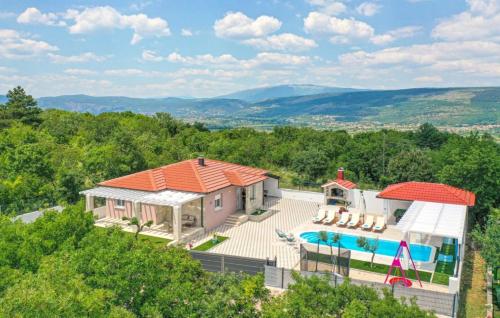 an aerial view of a house with a swimming pool at Villa Korana with heated Pool & Jacuzzi in Kamenmost