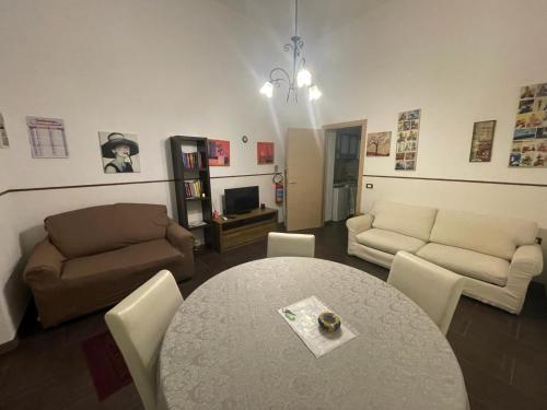 a living room with a table and a couch at Casa Frisella in Marsala