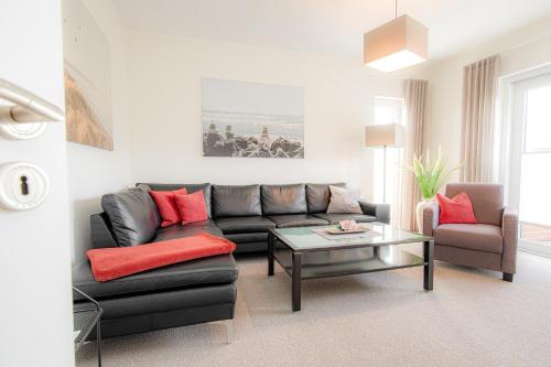 a living room with a couch and a table at Ferienhaus Coordtino in Putbus