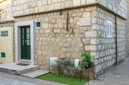 a table and two chairs in front of a building at Villa La Petra in Cavtat