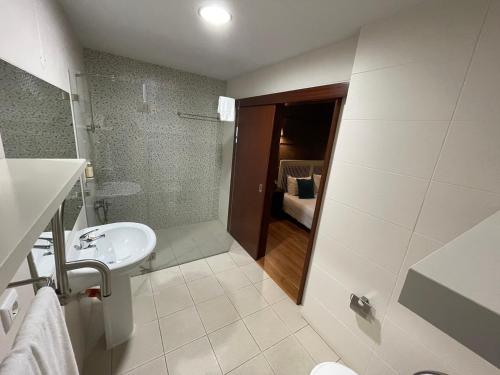 a bathroom with a sink and a toilet and a shower at Rilhadas Casas de Campo in Fafe