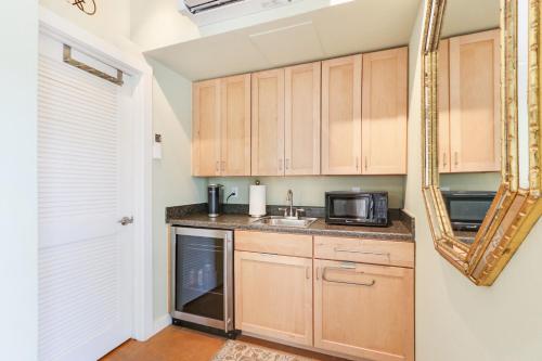 a kitchen with a sink and a microwave at Three Sisters - Casita 1 in Wimberley