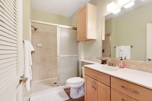 a bathroom with a shower and a toilet and a sink at Three Sisters - Casita 1 in Wimberley