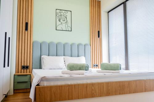 a bedroom with a large bed with a window at Cozy and Stylish Apartment 3 in Stara Zagora