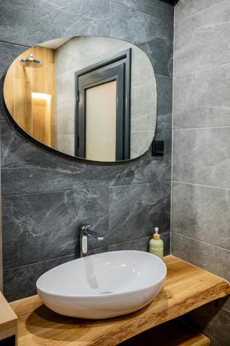 a bathroom with a white sink and a mirror at Cozy and Stylish Apartment 3 in Stara Zagora