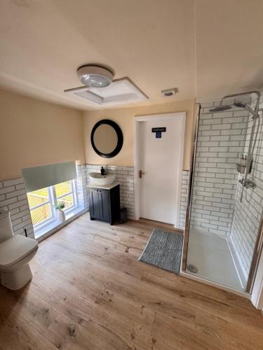 a bathroom with a shower and a toilet in a room at The World's End in Lowdham
