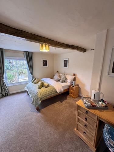 a bedroom with a bed and a large window at The World's End in Lowdham