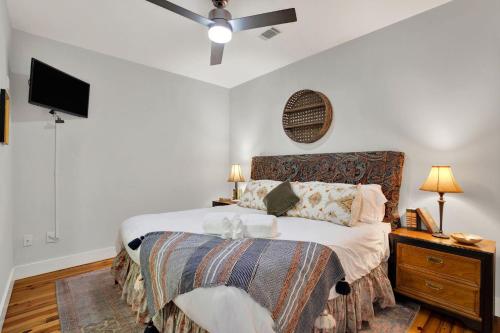 a bedroom with a bed and a flat screen tv at Above Broughton St 3002 in Savannah
