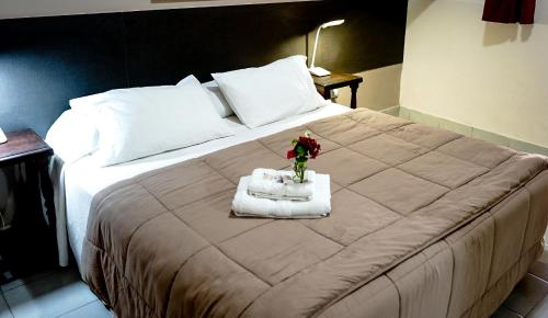 a bedroom with a large bed with flowers on it at Hotel de la Linda in Salta