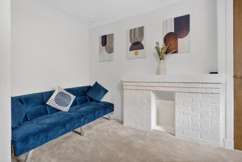 a blue couch in a living room with a fireplace at Seaside Snug in Largs