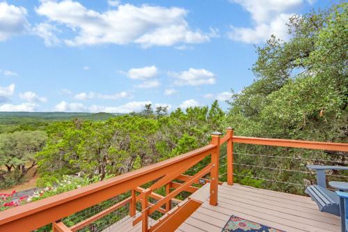 a wooden deck with a view of the trees at The Summit in Wimberley