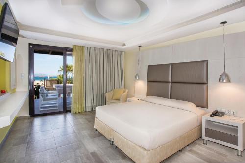 a hotel room with a bed and a balcony at Atlantis Hotel in Kos