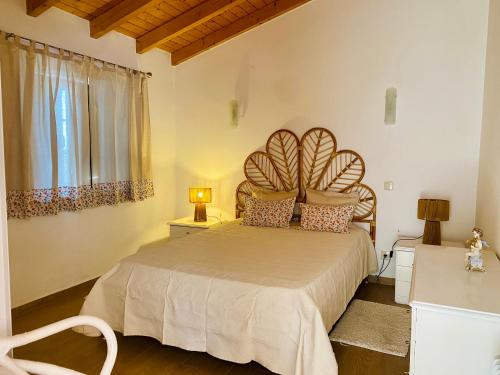 a bedroom with a large bed and a window at Casa do Ti Chico in São Luis