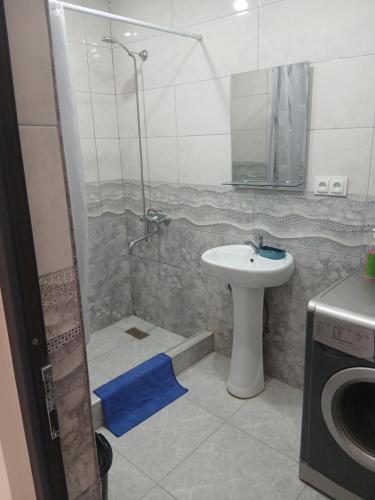 a bathroom with a shower and a sink and a toilet at Апартамент in Yerevan