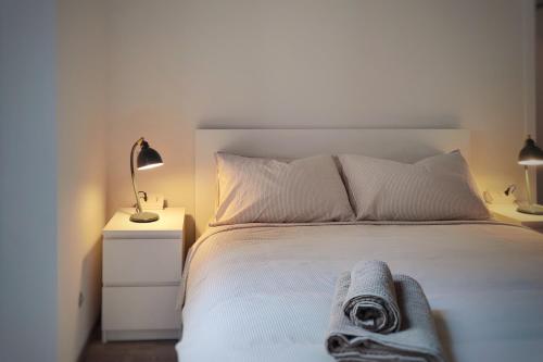 a bedroom with a bed with a towel on it at Otto Violini - City Center in Cremona