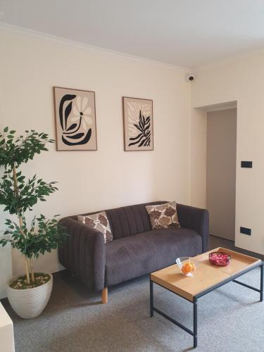 a living room with a couch and a coffee table at Villa Gold Poznań in Poznań