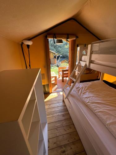 a bedroom with a bunk bed and a balcony at Bungalows Portuondo parking gratuito in Mundaka