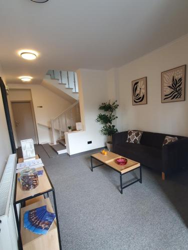 a living room with a couch and a table at Villa Gold Poznań in Poznań