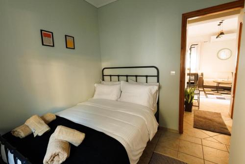 a bedroom with a bed with white sheets and pillows at Η Μουριά in Konitsa