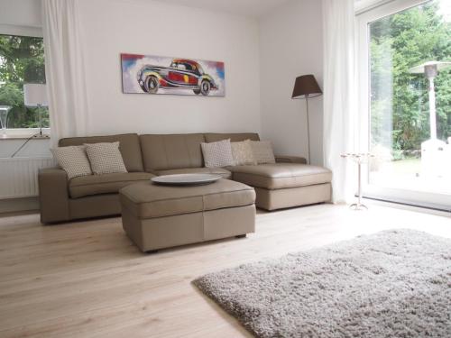 a living room with a couch and a table at Weedkroog in Timmendorfer Strand