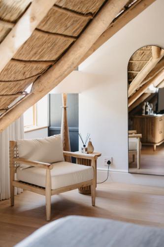 a living room with a chair and a table at Rickety Bridge Estate in Franschhoek