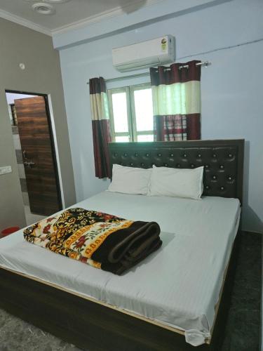 a bedroom with a bed with a blanket on it at Royal Rudraksh Palace in Bābatpur
