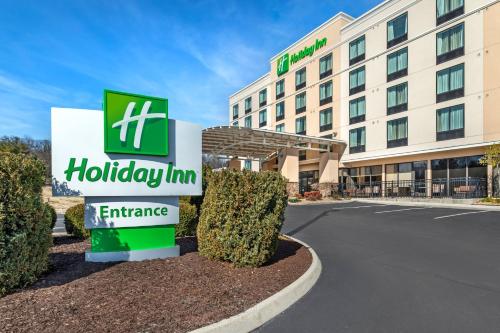 a hotel sign in front of a building at Holiday Inn Knoxville N - Merchant Drive by IHG in Knoxville