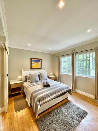 a bedroom with a large bed and a large window at Breede340 - Living the Breede in Malgas