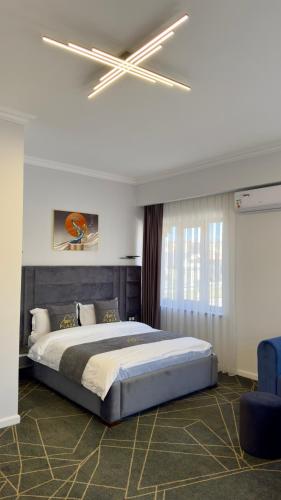 a bedroom with a large bed with a ceiling fan at Sim Plaza Hotel in Ejmiatsin