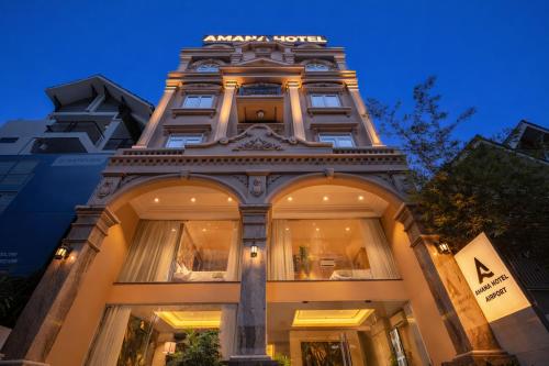 a building with a sign on top of it at Amana Hotel Airport in Ho Chi Minh City