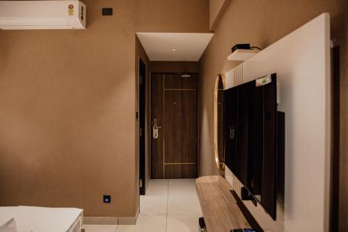 a hallway with a door and a stairway with a hallway at Varanashi Inn in Tiruppūr