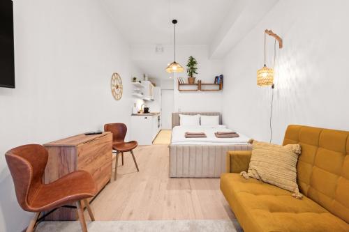 a living room with a couch and a bed at Marienholm Seaside Studio in Haapsalu