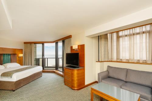 a hotel room with a bed and a couch at The View Hotel in Eastbourne