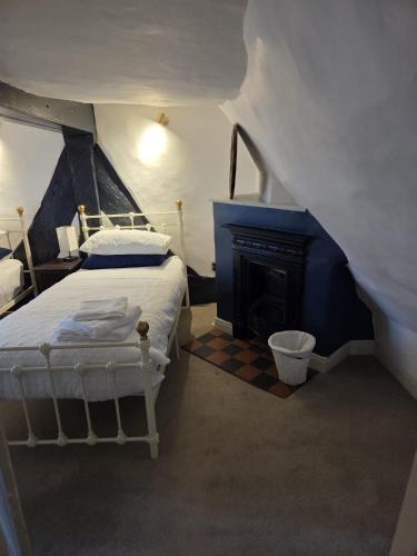 a bedroom with a bed and a fireplace at Stay in History 13th Century Gem in Central Shrewsbury! in Shrewsbury