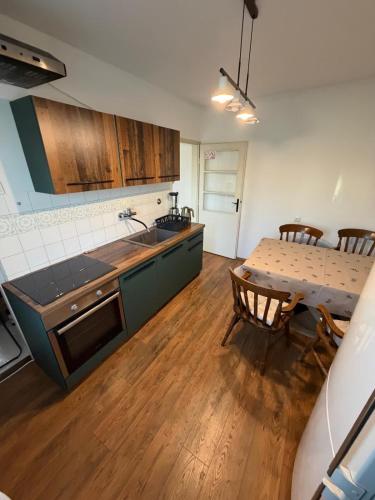 a kitchen and dining room with a table and a kitchen and a dining room at Magnolia guest house in Karlovac