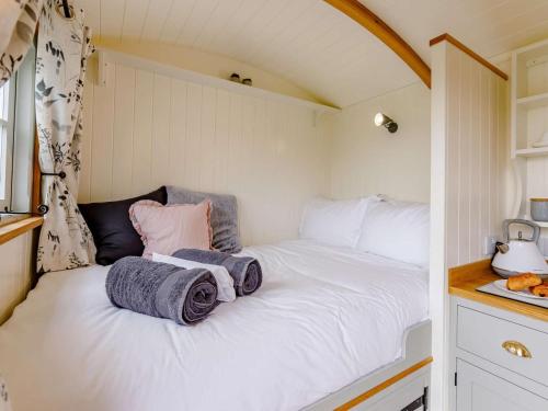 a bed in a small room with towels on it at 1 Bed in Boscastle oc-84015 in Boscastle