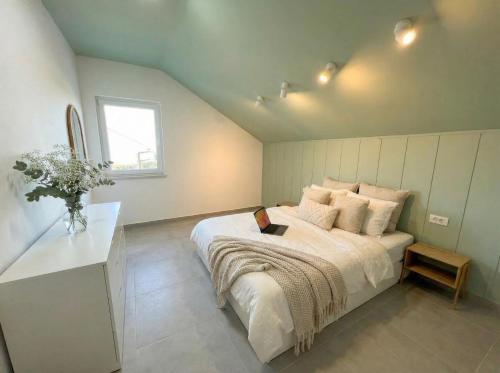 a bedroom with a large bed and a window at Penthouse SKY DELUXE in Novalja