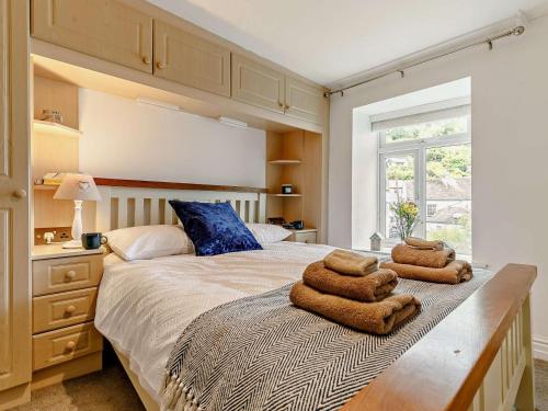 a bedroom with a bed with two towels on it at 3 Bed in Looe oc-92273 in Polperro