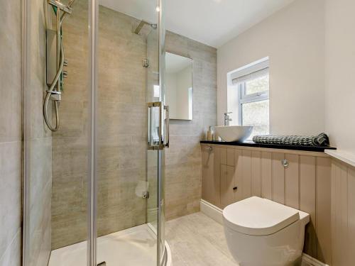 a bathroom with a shower and a toilet and a sink at 3 Bed in Looe oc-92273 in Polperro