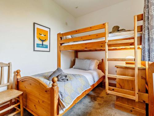 a bedroom with two bunk beds and a desk at 2 Bed in Fowey oc-55381 in Golant