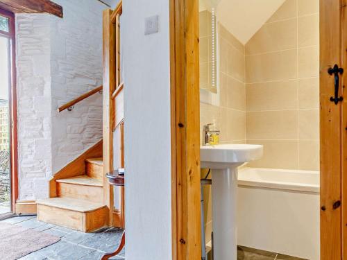 a bathroom with a sink and a bath tub at 2 Bed in Fowey oc-55381 in Golant
