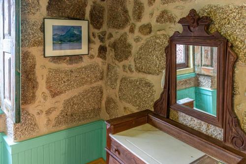 a room with a window and a mirror on a wall at Guest H4U - Nature & Pool Guarda in Seixo Amarelo