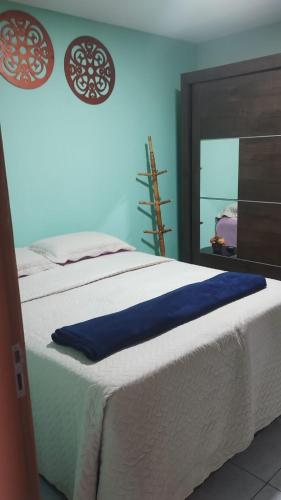 a bedroom with a large bed with a mirror at Acomodações em Bananeiras, PB in Bananeiras